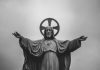grayscale photograph of Jesus Christ statue