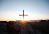 brown cross on brown rock during daytime