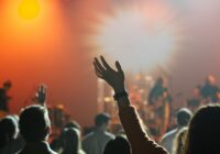 shallow focus photography of hand and people