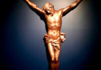 a statue of jesus on a cross in the dark