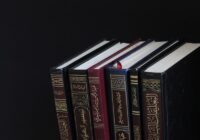 piled books on black surface