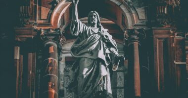 man in robe statue in cathedral