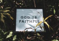 God is Faithful signage with leaved background