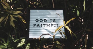 God is Faithful signage with leaved background