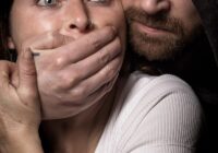 man apprehending woman in white tank top