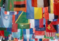 a bunch of flags hanging from a pole