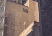 low angle photography of concrete building with cross