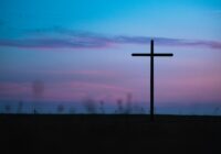 cross stand under purple and blue sky