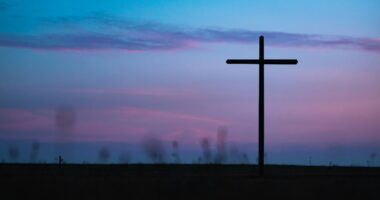 cross stand under purple and blue sky