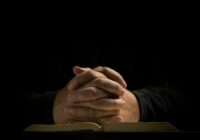 a person's hands on a book